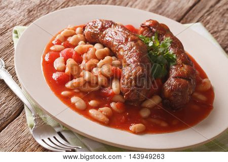 Grilled Sausage With Beans In Tomato Sauce On A Plate Close-up. Horizontal