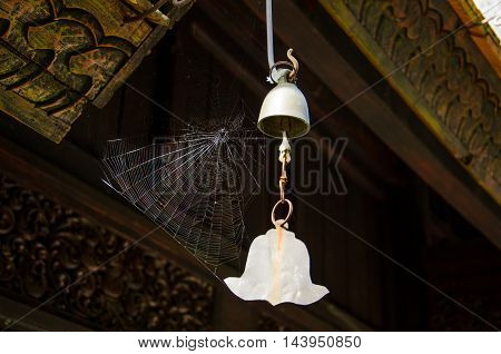Old small iron bell with spider web