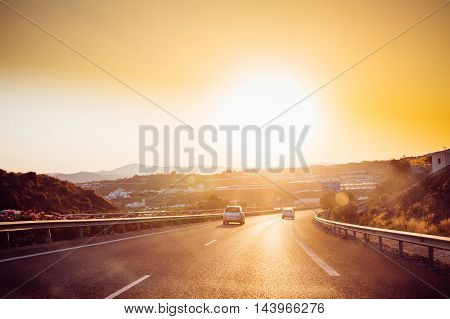 Malaga, Spain - June 20, 2015: The movement of vehicles on freeway, motorway E-15 near Malaga in Spain. Sunset time
