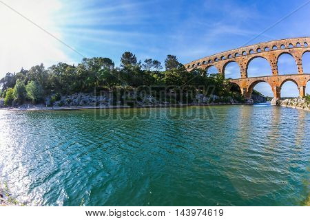  Provence, spring sunny day. Three-tiered aqueduct Pont du Gard - the highest in Europe. The bridge was built in Roman times on the river Gardon