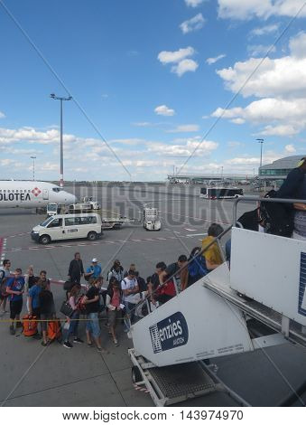 Passengers Boarding On A Plane