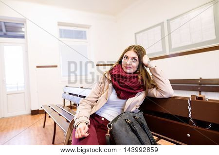 Beautiful Young Woman Traveling, Sitting In Bus Waiting Room