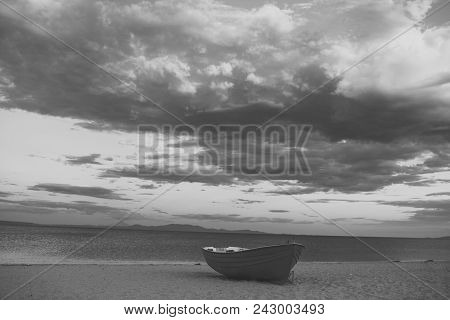 Fishing Boat On Beach In Evening. Travel And Rest Concept. Background Of Sea With Waves And Sky With