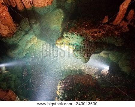A Wishing Well With Water In Cave Or Cavern With Coins