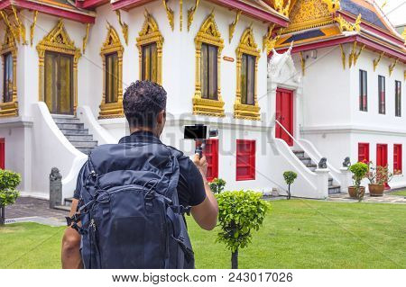 Man Backpacher Who Holds Mobile Phone On Gimbal Visiting Asia During A Sunny Day , Solo Trip , Holid