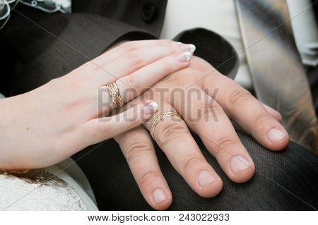 Groom With The Bride Holding Hands Together With Wedding Rings