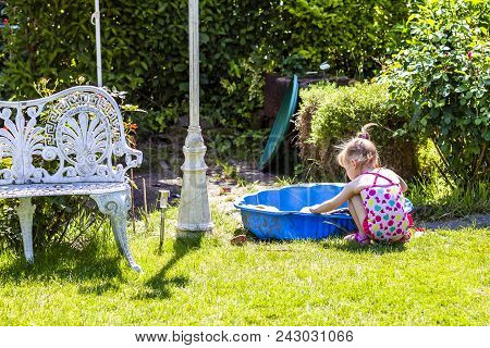 Adorable Little Girl Playing In A Sandbox.