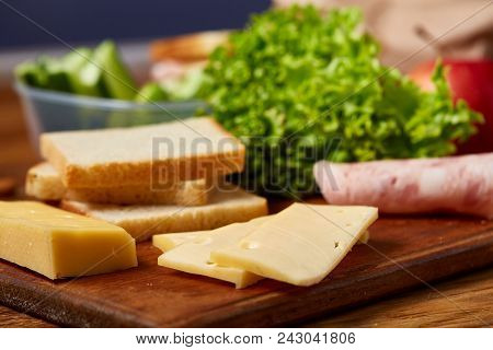 Preparing Ham And Cheese Sandwiches For School Lunchbox On Wooden Background, Close Up. Healthy Eati