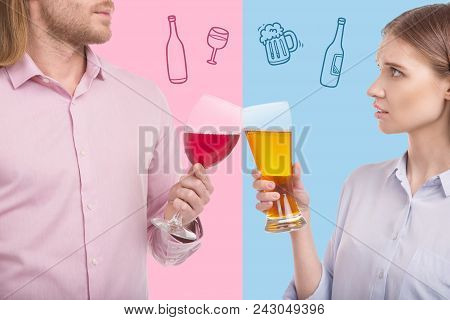 Clanging Glasses. Serious Woman Looking At Her Husband While Clanging Glasses With Him