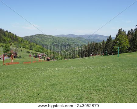 Countryside Landscapes Of Grassy Field And Forest At Beskid Mountains Range In European Salmopol Pas