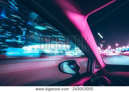 Car Speed Drive On The Road In Night City. Retro Wave Neon Noir Lights Color Toning
