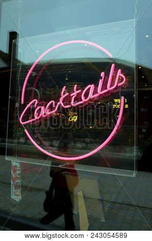 Bracknell, England - May 30, 2018: A Passerby Reflected In The Window Display Sign Advertising Cockt