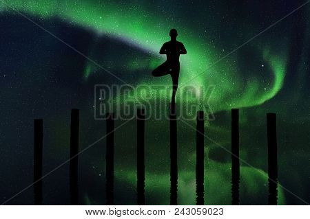 Yoga At Night. Vector Illustration With Silhouette Of Yogi Standing On Log. Northern Lights In Starr