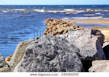 Sandy Beach, Pieces Of Dried Cane, Stone Wall