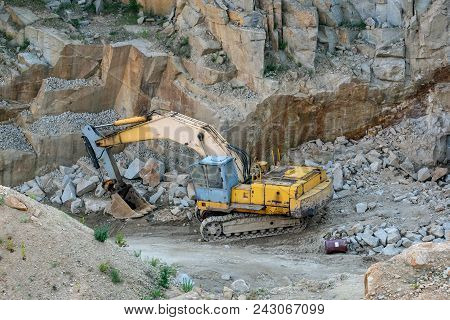 Mining In The Granite Quarry. Working Mining Machine - Old Digger. Mining Industry.
