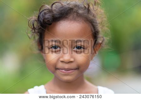 KUALA WOH, MALAYSIA, FEBRUARY 22, 2018 : Portrait of a smiling sweet little girl, member of an Orang Asli tribe in Kuala Woh, Perak province, Malaysia