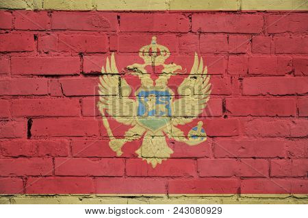 Montenegro Flag Is Painted Onto An Old Brick Wall