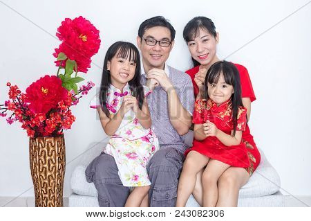 Asian Chinese Family With Greeting Gesture Celebrating For Chinese New Year At Home