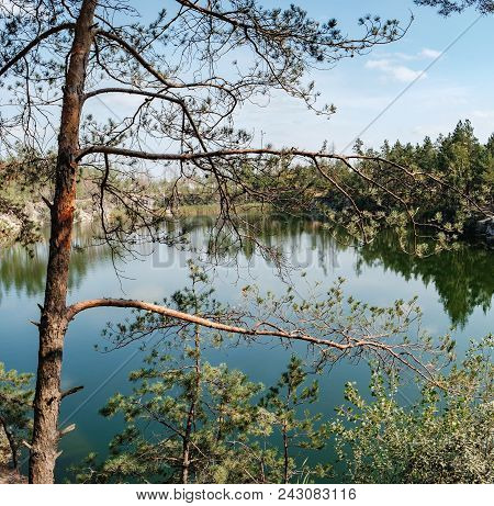 Picturesque Landscape With A Lake In The Middle Of A Coniferous Forest In Korostyshiv Quarry, Zhytom