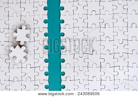 The Blue Path Is Laid On The Platform Of A White Folded Jigsaw Puzzle. The Missing Elements Of The P