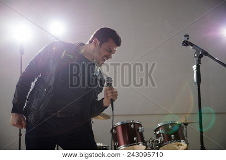 Rock Band Lead Singer Singing His Heart Out On Stage