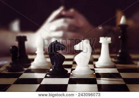 Man Playing Chess, The Success Of The Mind. Crossed The Blurred Hand In The Background.