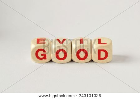 Good And Evil Written With Wooden Cubes