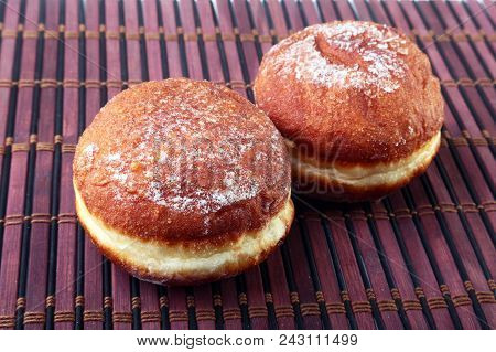 Homemade Doughnuts With Jelly Filled And Powdered Sugar On Bamboo Tablecloth. Selective Focus