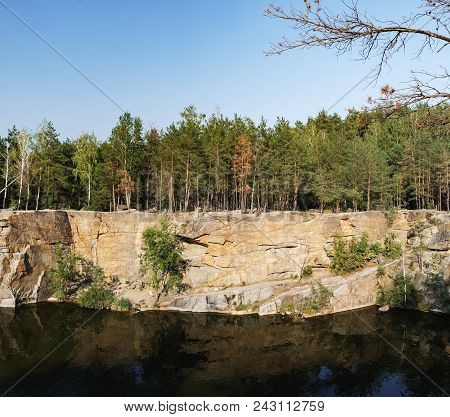 Picturesque Landscape With A Lake In The Middle Of A Coniferous Forest In Korostyshiv Quarry, Zhytom