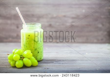 Freshly Squeezed Fruit Juice, Smoothies Greengrape Strawberry On A Dark Wooden Background Copy Space