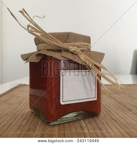 Traditional Serbian Food Ajvar In The Glass Jar. Ajvar Is A Pepper-based Condiment Made Principally 