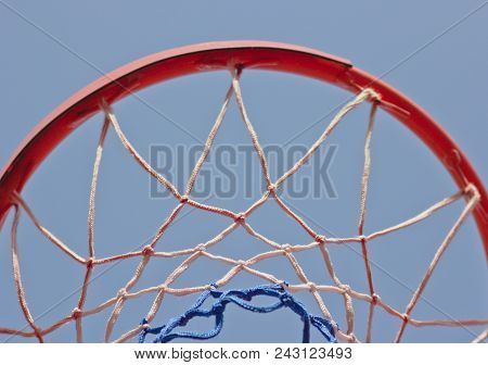 Close-up Basketball Hoop Rim, Up Ward View A Hoop Under Blue Sky