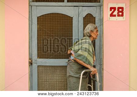 Old Indian Woman Stands With Go-carts Near The Entrance To Residental Barrack 8 February 2018 Sai Ba