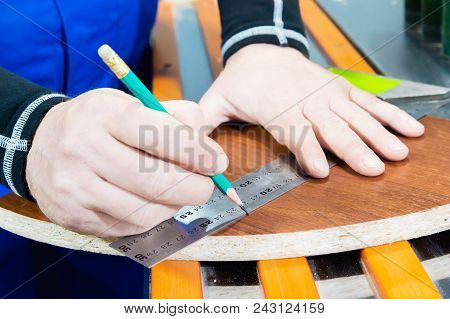 Close-up Of The Hand Of The Carpenter's Master Is Marked With A Ruler And A Pencil Blank. The Concep