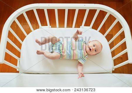Baby Girl In Co-sleeper Attached To Parents' Bed