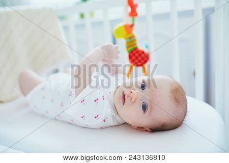 Baby Girl Lying In Co-sleeper Attached To Parents' Bed