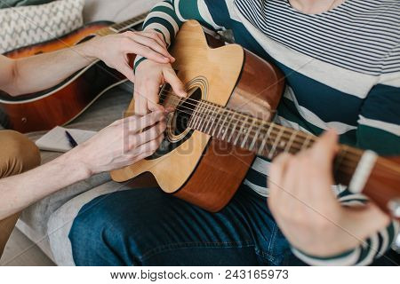 Learning To Play The Guitar. Music Education And Extracurricular Lessons.