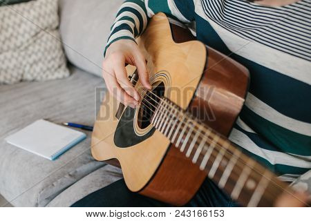 Learning To Play The Guitar. Music Education And Extracurricular Lessons.