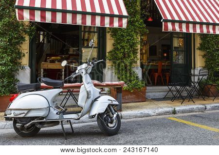 Athens, Greece - May 25, 2018: Motorbike In Front Of A Coffee Shop In A Street Of Psyri Neighborhood