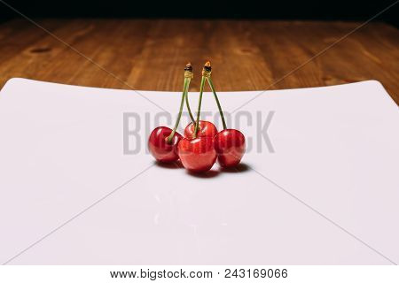 Fresh Cherry On Plate On Wooden Blue Background. Fresh Ripe Cherries. Sweet Cherries. Close Up