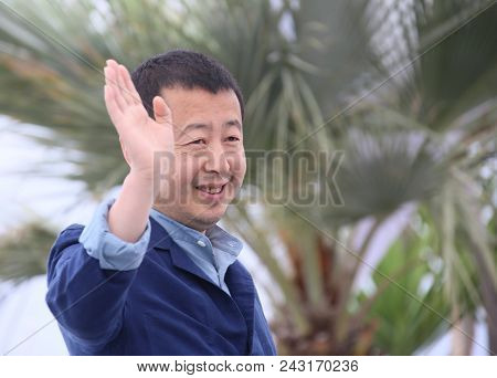 Jia Zhang-Ke waves at the photocall for 'Ash Is The Purest White (Jiang Hu Er Nv)' during the 71st annual Cannes Film Festival at Palais des Festivals on May 12, 2018 in Cannes, France.