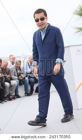 Jia Zhang-Ke waves at the photocall for 'Ash Is The Purest White (Jiang Hu Er Nv)' during the 71st annual Cannes Film Festival at Palais des Festivals on May 12, 2018 in Cannes, France.