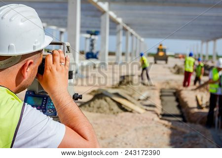 Surveyor Engineer Is Measuring Level On Construction Site. Surveyors Ensure Precise Measurements Bef