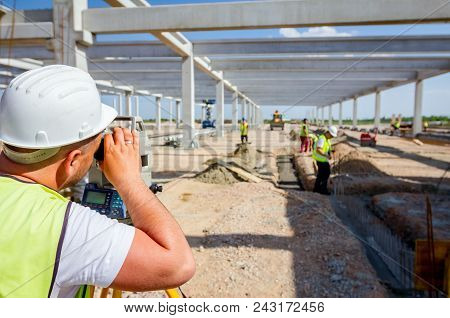 Surveyor Engineer Is Measuring Level On Construction Site. Surveyors Ensure Precise Measurements Bef