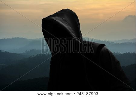 Unrecognizable Black Hooded Man On Nature Background