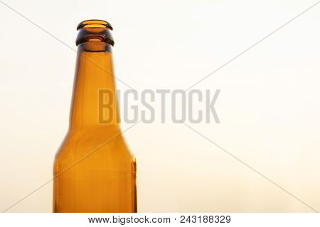 Empty Yellow Beer Bottle On Isolated Background