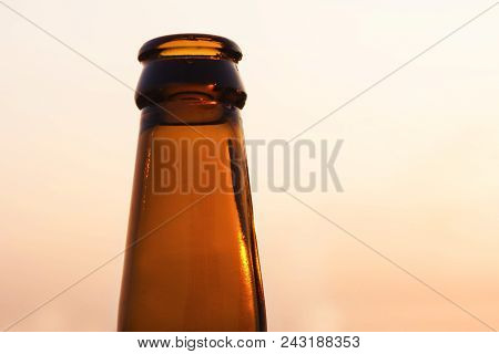 Empty Yellow Beer Bottle On Isolated Background