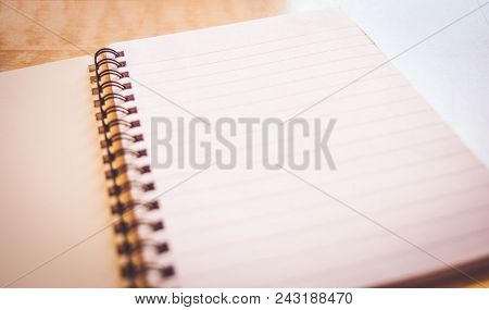 Spiral Notebook On The Abstract Wooden Table