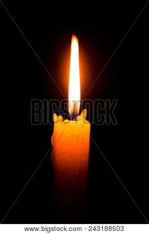 abstract Single lit candle with quite flame