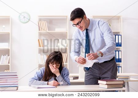 Male lecturer giving lecture to female student